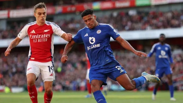 Arsenal's Belgian midfielder #19 Leandro Trossard (L) vies with Leicester City's English defender #02 James Justin (R) during the English Premier League football match between Arsenal and Leicester City at the Emirates Stadium