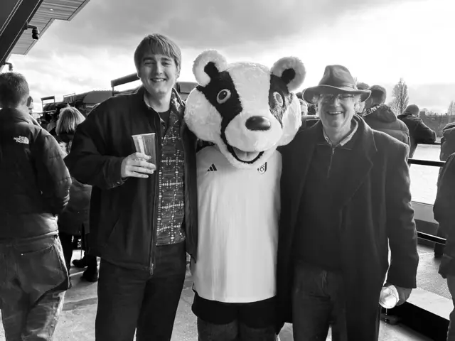 Son and father with a Fulham mascott.