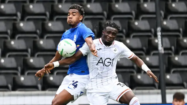 Jhon Solis of Birmingham City is challenged by Joseph Opoku of Swansea City