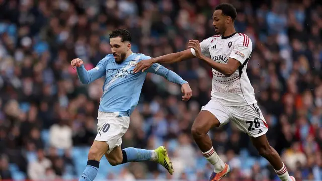 Rayan Cherki challenged by Zach Awe