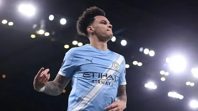 Nico O'Reilly celebrates scoring under the lights at the Etihad