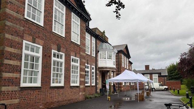 The front of a large two-storey, red brick, building which was once a school