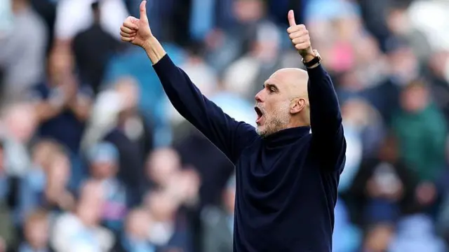  Pep Guardiola, Manager of Manchester City, acknowledges the fans