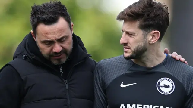 Roberto de Zerbi hugs Adam Lallana