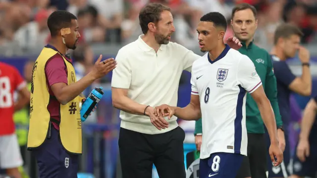 England's Trent Alexander-Arnold shakes hands with manager Gareth Southgate as he is substituted.