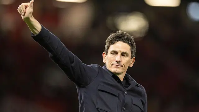 Keith Andrews gestures to the travelling support inside Old Trafford 