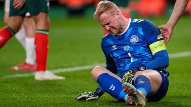 Goalkeeper Kasper Schmeichel of Denmark is helped by teammate during the UEFA Nations League Quarterfinal Leg Two match between Portugal and Denmark at Estadio Jose Alvalade 