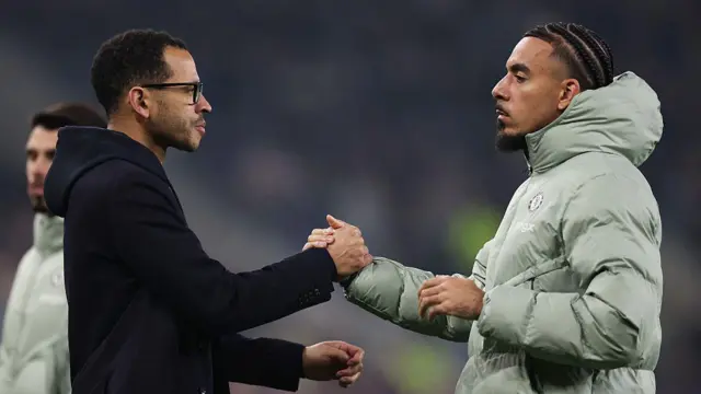 Liam Rosenior and Malo Gusto shake hands at the end of Chelsea match