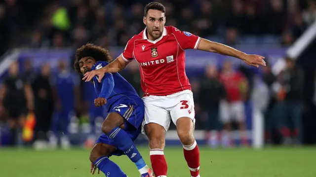 Matty James in action for Wrexham against Leicester City's Hamza Choudhury 