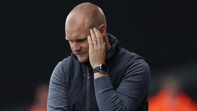 Liam Manning looks dejected