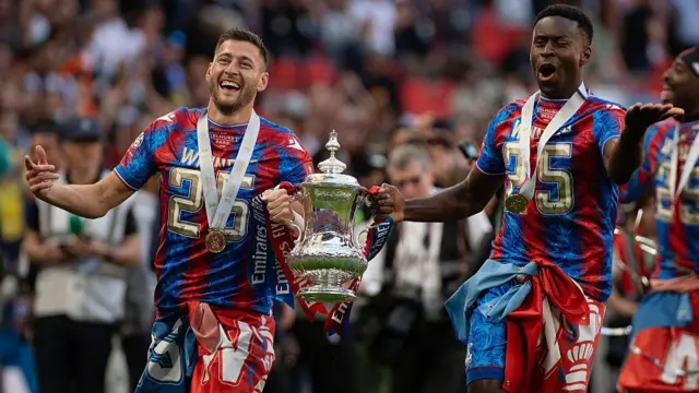 Joel Ward and Marc Guehi celebrate with the FA Cup