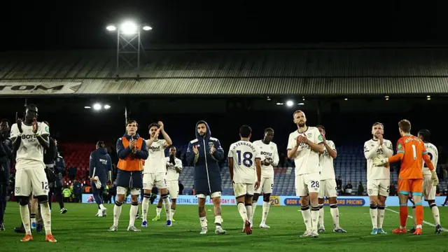 West Ham players applaud the fans.