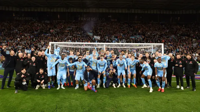 Coventry City's players and staff celebrate on the pitch at the CBS Arena after sealing the Championship title