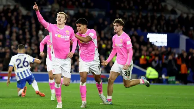 Flynn Downes of Southampton celebrates with team mates Mateus Fernandes and Tyler Dibling(R) behind during the Premier League match between Brighton & Hove Albion FC and Southampton FC at Amex Stadium on November 29, 2024