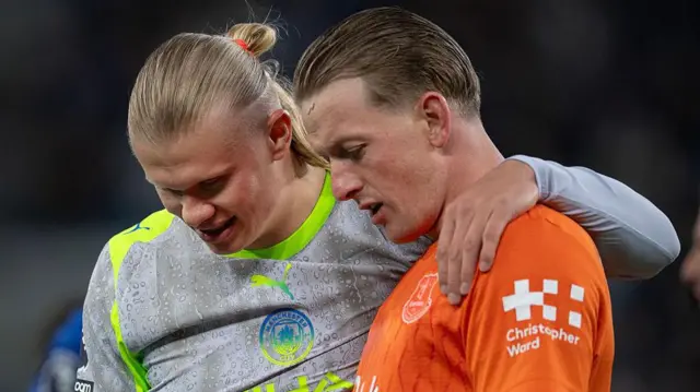 Erling Haaland and Jordan Pickford embrace and chat