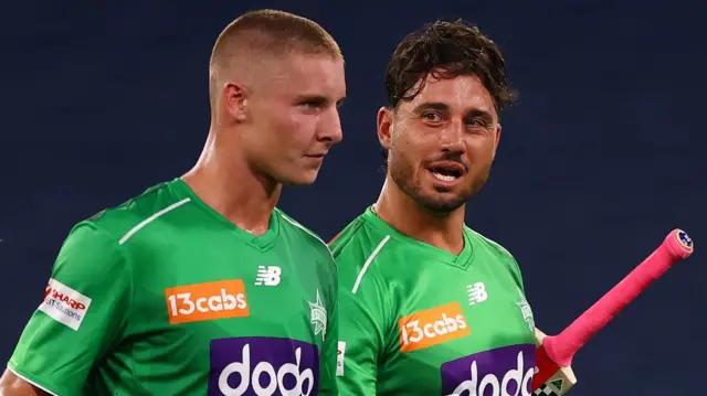Melbourne Starts batters Campbell Kellaway (left) and Marcus Stoinis (right) walk off after beating Hobart Hurricanes