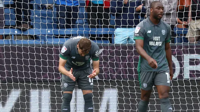 Callum Chambers bends over in frustration and Yakou Meite walks away from the goal during Cardiff City's 5-0 defeat at Burnley