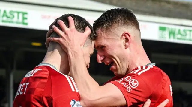 Kevin Nisbet is embraced by Ante Palaversa