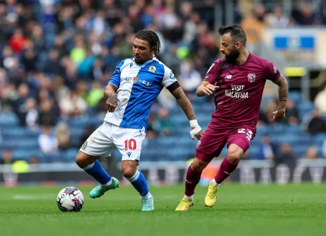 Blackburn Rovers' Tyrhys Dolan passes the ball under pressure from Cardiff City's Manolis Siopis 