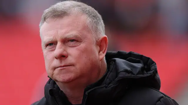 Stoke City manager Mark Robins looks pensively into the distance from the touchline