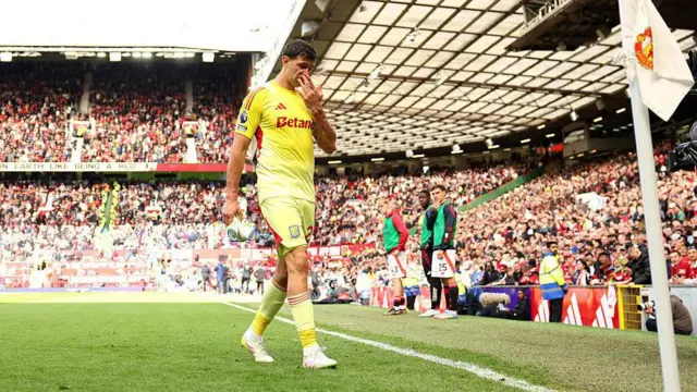 Emi Martinez looks dejected after being sent off at Old Trafford