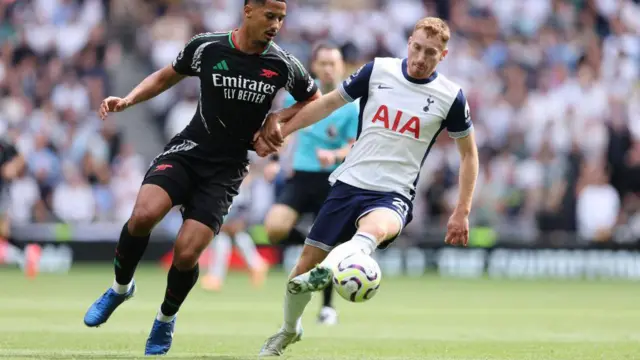 Tottenham's Dejan Kulusevski battles for possession with William Saliba of Tottenham