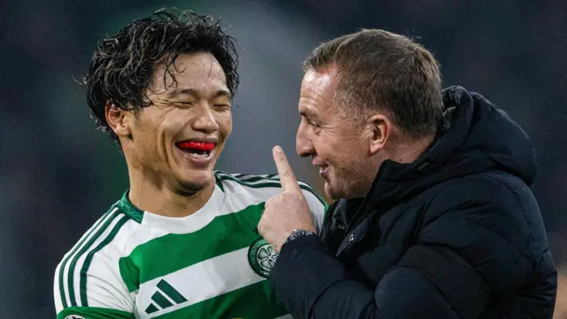 Celtic midfielder Reo Hatate laughs with manager Brendan Rodgers