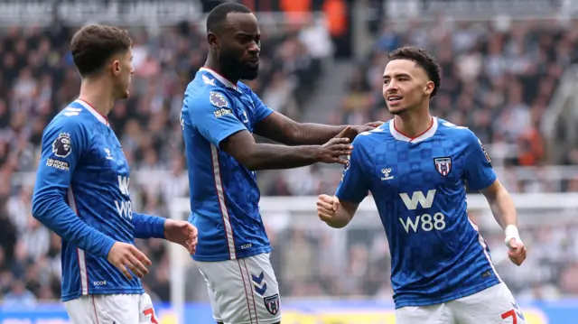 Sunderland players celebrate a goal at Newcastle