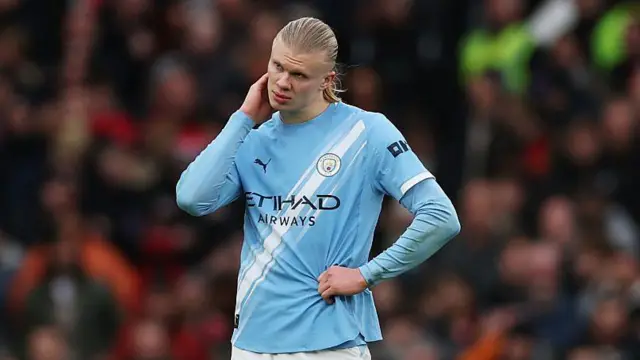 Erling Haaland with his hand on his head 