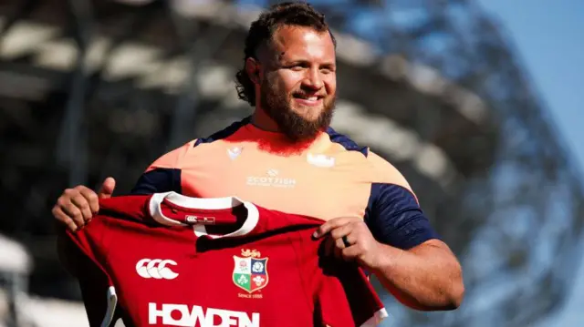 Edinburgh prop Pierre Schoeman poses with a Lions shirt at Murrayfield