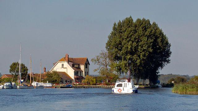 A boat on the River Yare outside the Beauchamp Arms pub in Langley