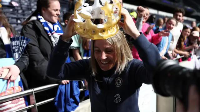 Sonia Bompastor puts on a blow up crown