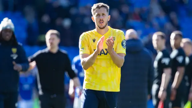 Will Vaulks of Oxford United applauds supporters 
