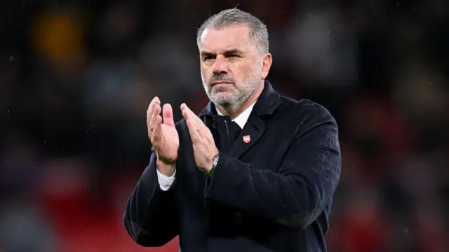 Tottenham manager Ange Postecoglou applauds Tottenham's away fans following victory over Manchester United