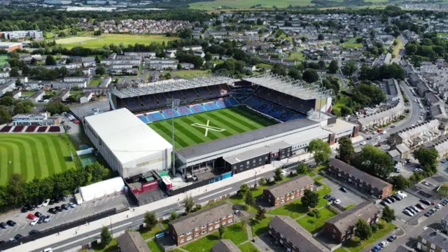 General aerial view of Turf Moor with X logo on the pitch