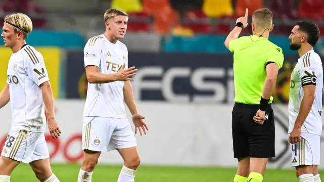 Aberdeen’s Alexander Jensen is shown a red card by Referee Espen Eskas following a second yellow card offence during a UEFA Europa League Play-offs Second Leg match between FCSB and Aberdeen at the National Arena