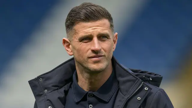 Portsmouth boss John Mousinho looks on 