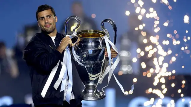 Manchester City midfielder Rodri poses with the Champions League trophy