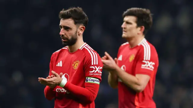 Bruno Fernandes and Harry Maguire applaud fans