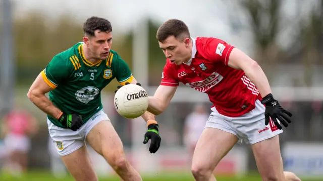 Donal Keogan (Meath) and Luke Fahy (Cork) battle for possession 
