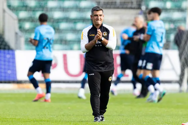 Newport County manager Nelson Jardim applauds on the pitch 