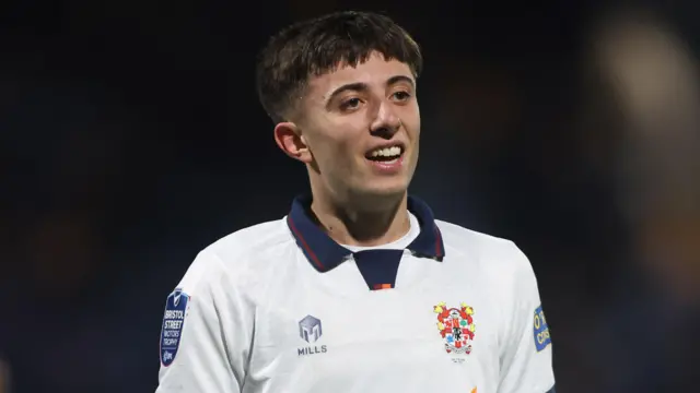 Sam Taylor, wearing Tranmere's white shirt with a navy blue collar, during an EFL Trophy game against Stockport in November 2024