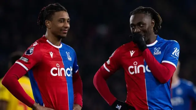 Olise and Eze of Crystal Palace discuss something on the pitch