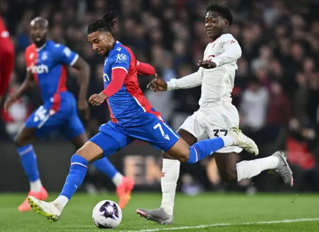 Michael Olise running with the ball against Manchester United