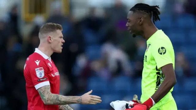 Wrexham wing-back James McClean (L) celebrates with goalkeeper Arthur Okonkwo