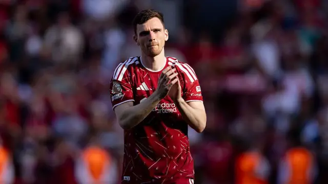 Andy Robertson applauds the Liverpool fans.