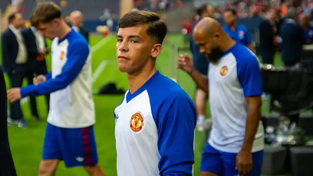 Shea Lacey of Manchester United enters the pitch