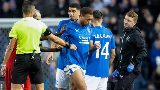 Rangers' Cyriel Dessers (centre) goes off injured against FCSB