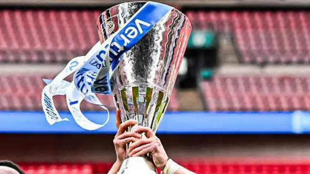 The EFL Trophy is held aloft