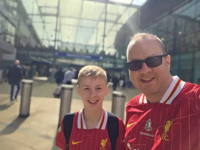 Stuart and his son on the way to the trophy celebrations